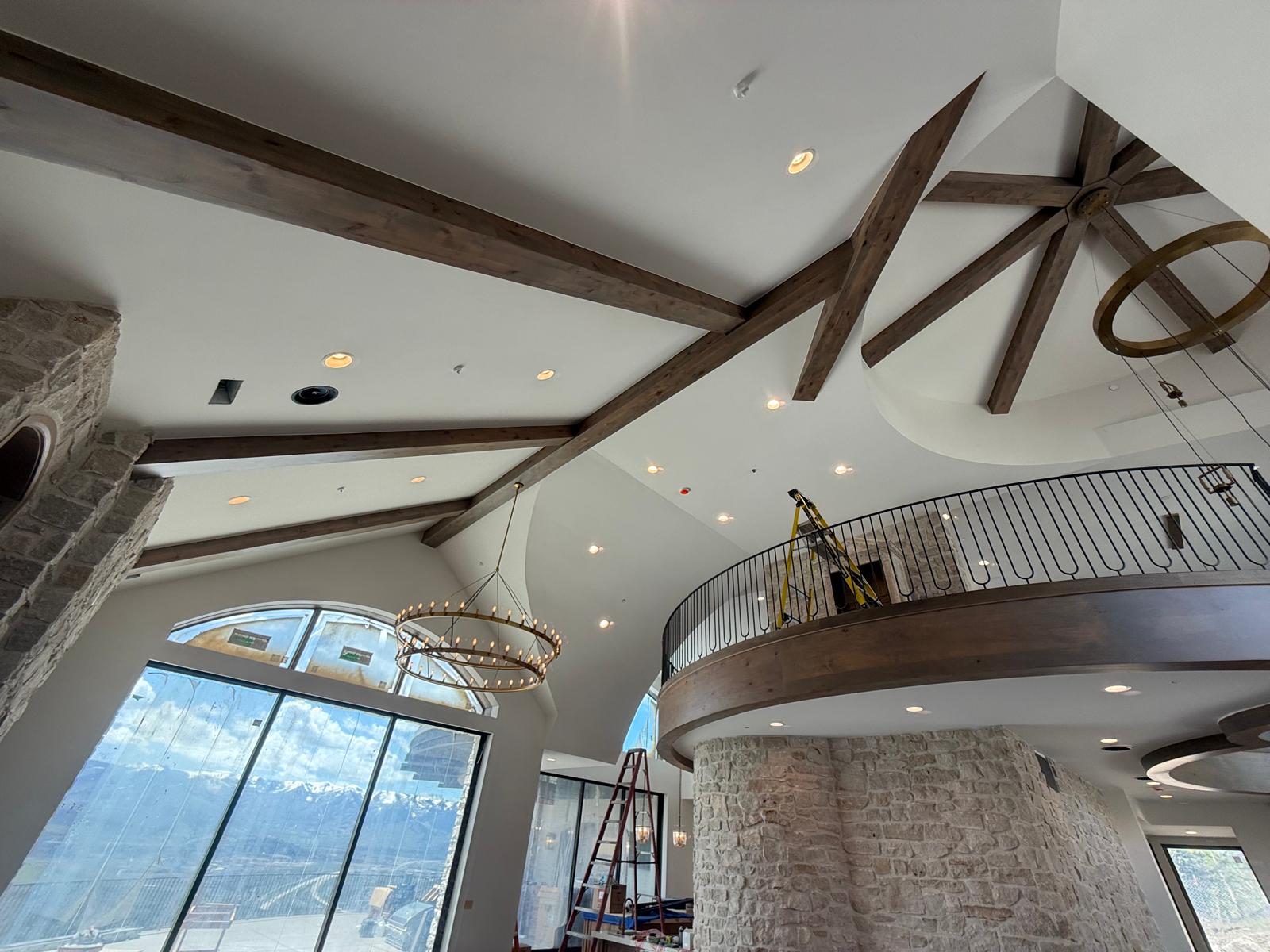 Vaulted ceiling with wood beams and ring chandelier